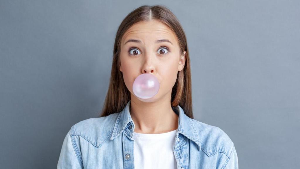 Woman making a balloon with a piece of gum.