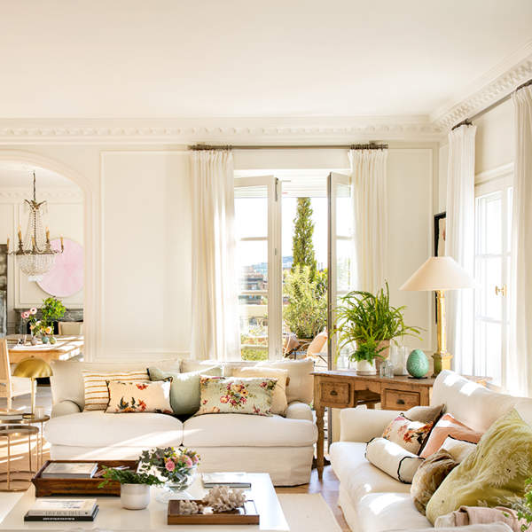 Elegant living room with white sofas, marble fireplace and custom shelving